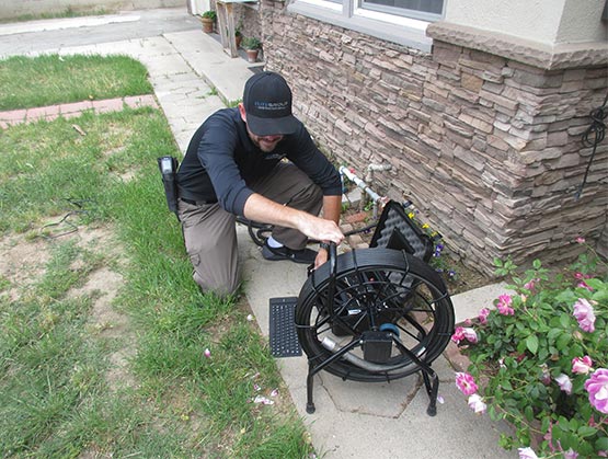 Man performing a sewer scope inspection on a property